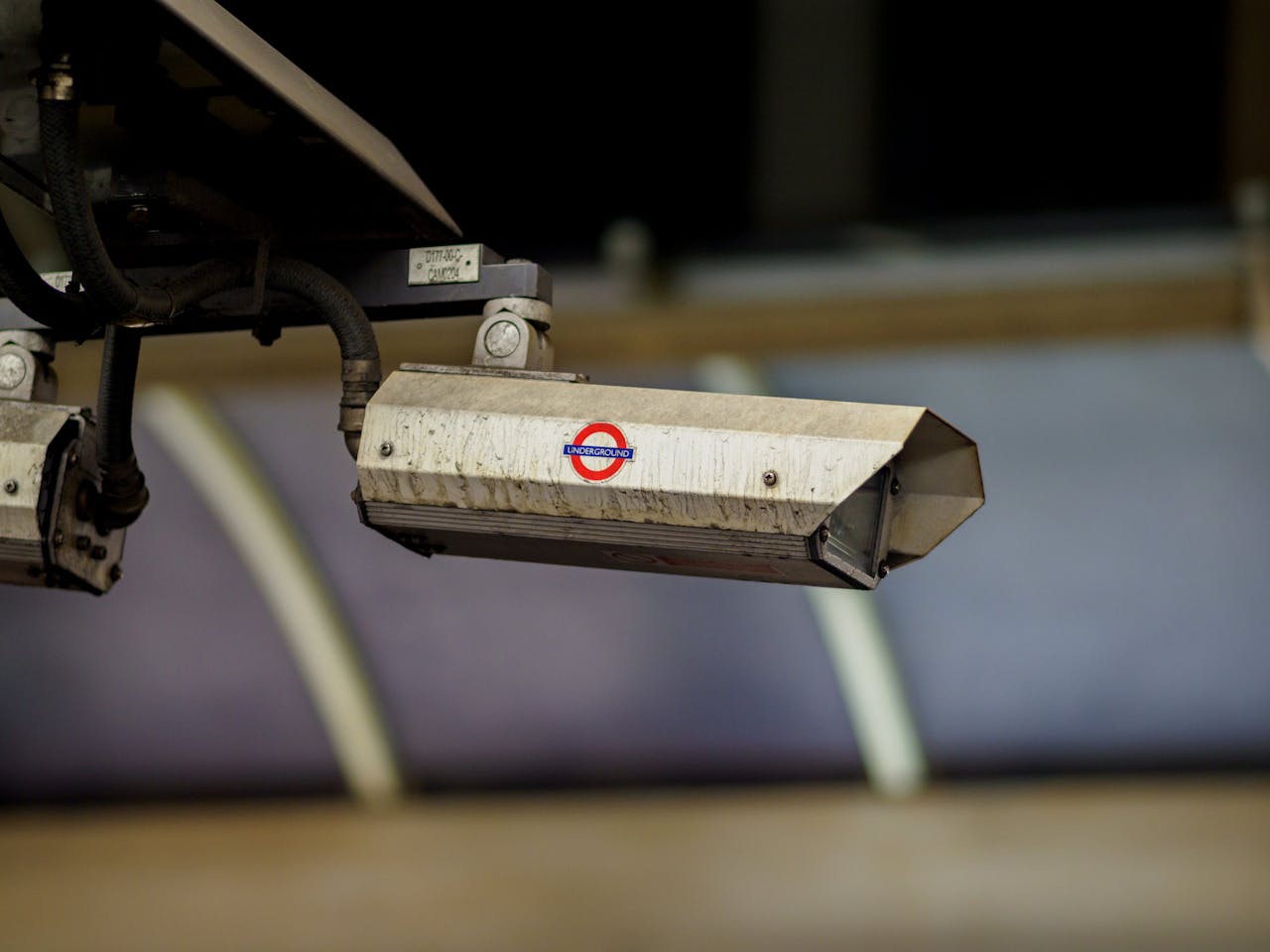Close-up of a CCTV camera installed at a London Underground station for security surveillance.